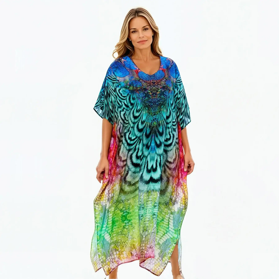 Woman wearing a vibrant, peacock-print kaftan dress by Claire Powell, eco-friendly fashion