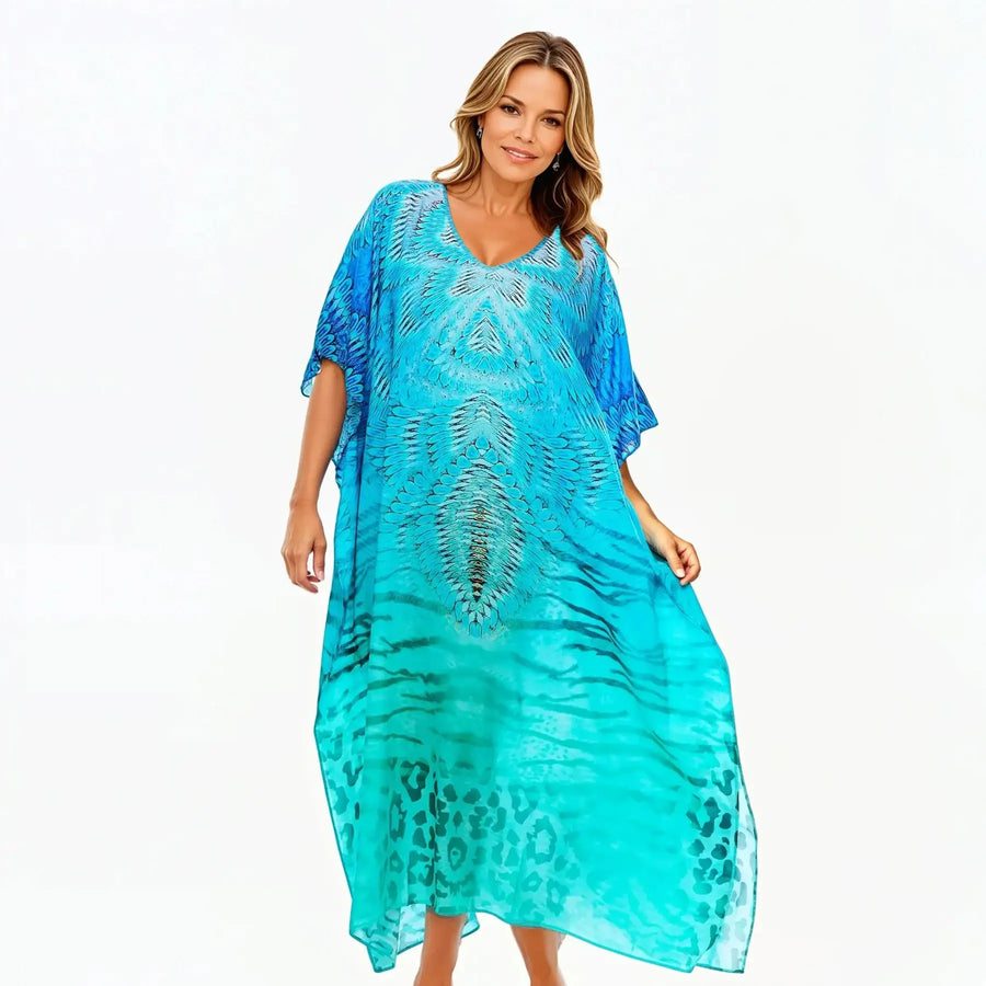 Woman modeling blue patterned kaftan dress from Claire Powell, stylish eco-friendly fashion