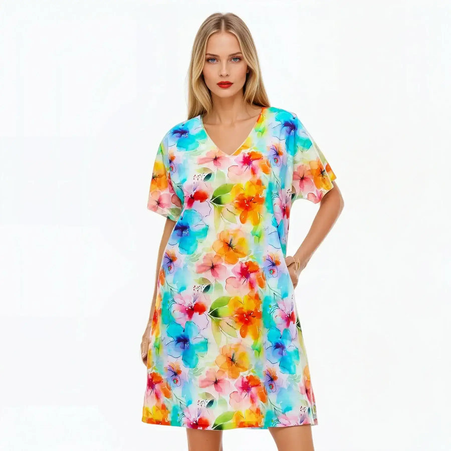 Woman wearing a colorful floral V-neck midi shift dress, Claire Powell summer fashion