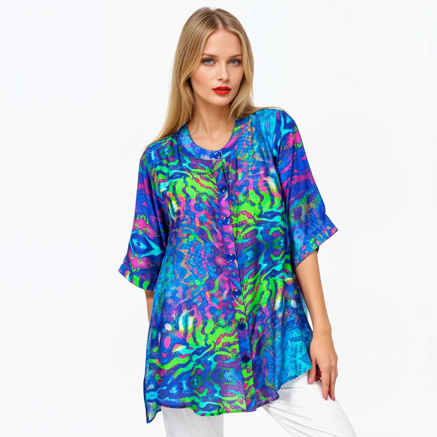 Woman wearing Claire Powell A-line Tunic Blouse in Mirage print, blue, violet and teal, front view