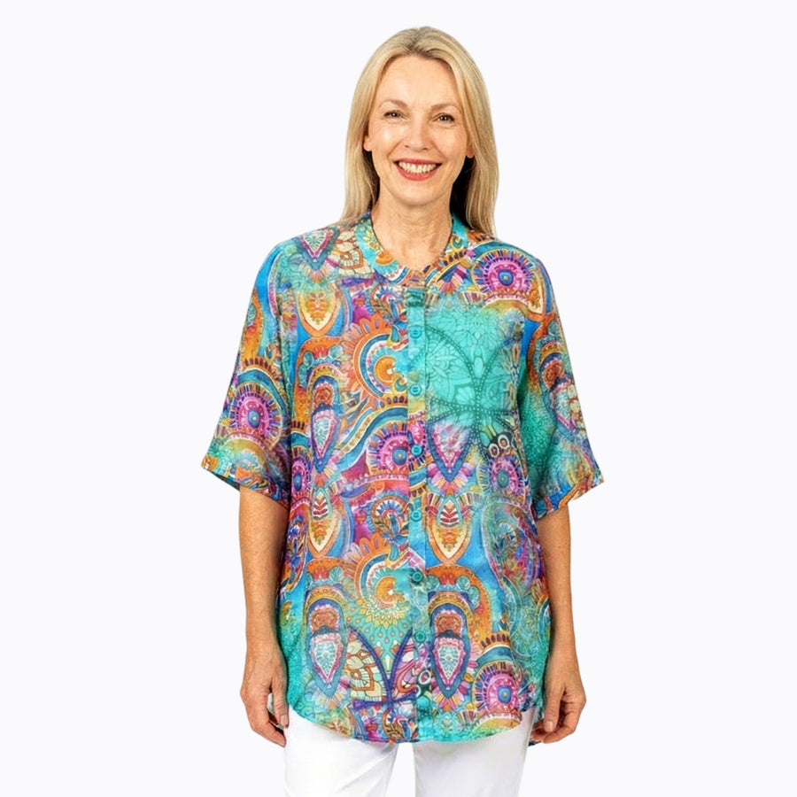 Woman wearing Claire Powell A-line Tunic Blouse in Mosaic print, teal, cobalt and magenta tiles, front view