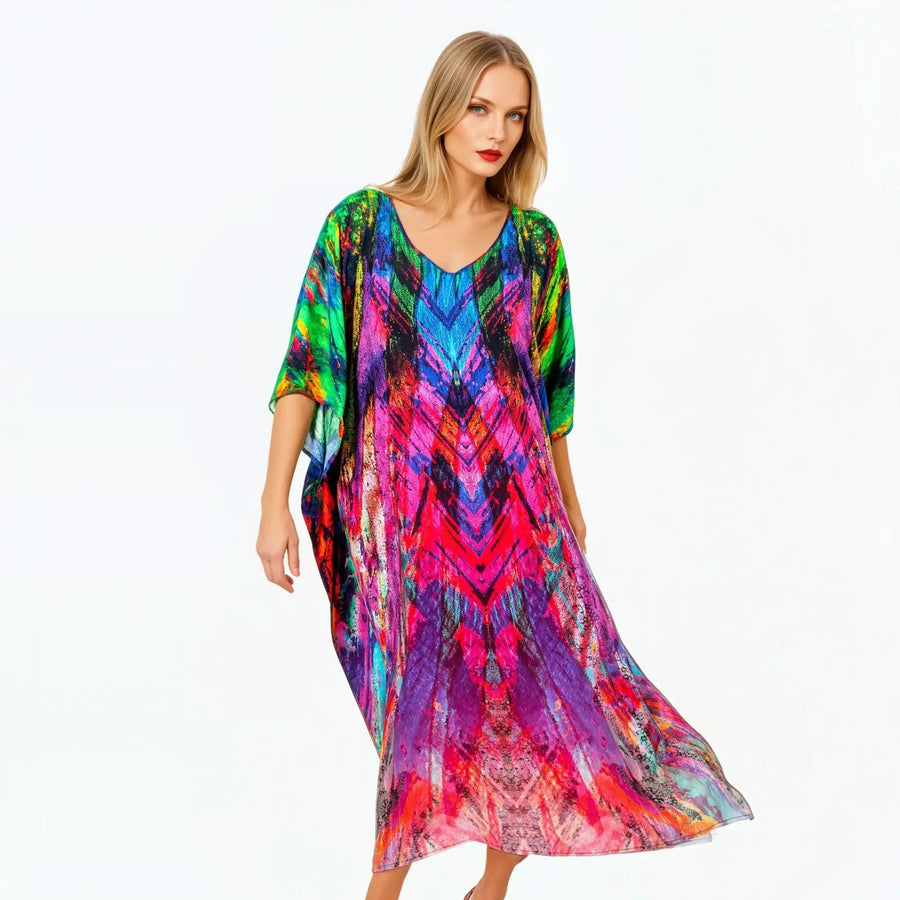 Woman wearing vibrant multicolor kaftan dress by Claire Powell, eco-friendly fashion