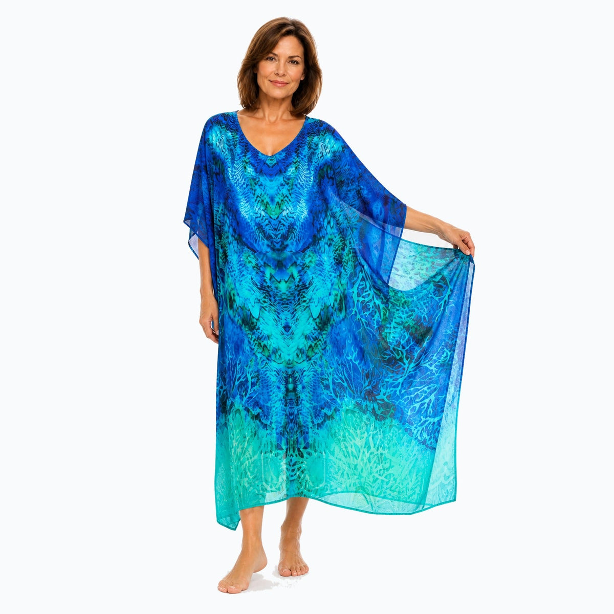 Claire Powell Aquatica midi kaftan dress on a mature woman, fabric-showing pose