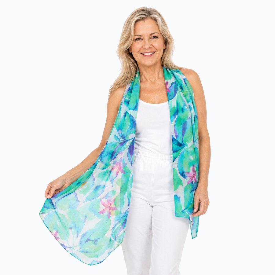 Woman wearing the Claire Powell Broome scarf, front view with one end extended to show the print