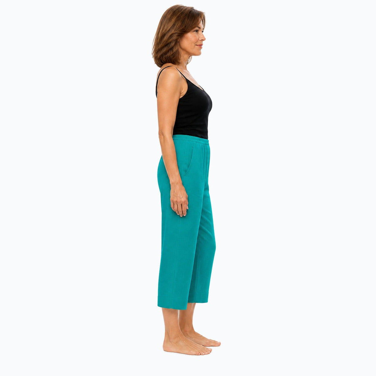 Woman wearing the Claire Powell Jade Viscose 7/8 Pants, side view