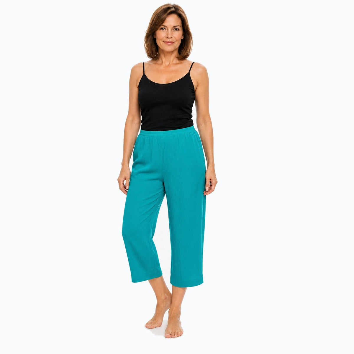 Woman wearing the Claire Powell Jade Viscose 7/8 Pants, three-quarter view