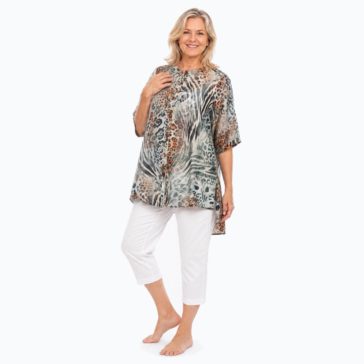 Woman wearing the Claire Powell Jungle A-Line Tunic Shirt with white capri pants, full-body view