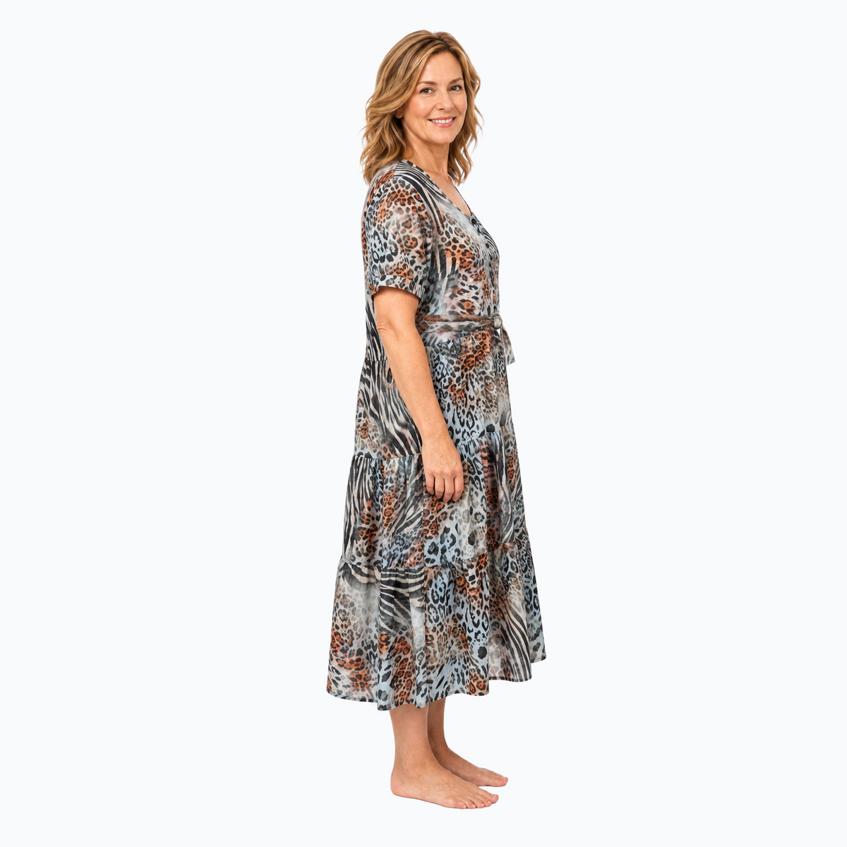 Model D wearing the Claire Powell Tiered A-line Midi Dress in Jungle with matching-fabric tie belt, side view