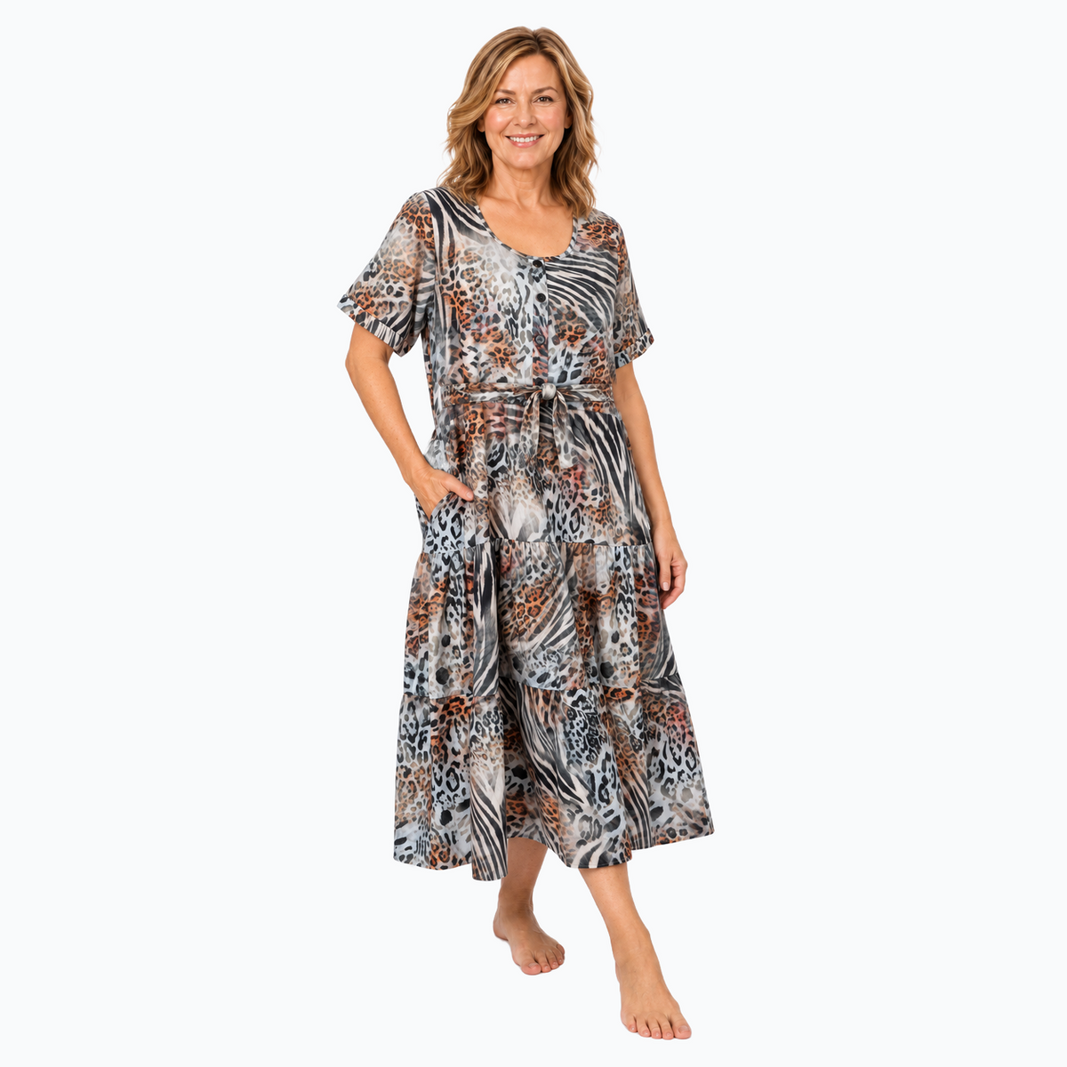 Model D wearing the Claire Powell Tiered A-line Midi Dress in Jungle with matching-fabric tie belt, three-quarter view