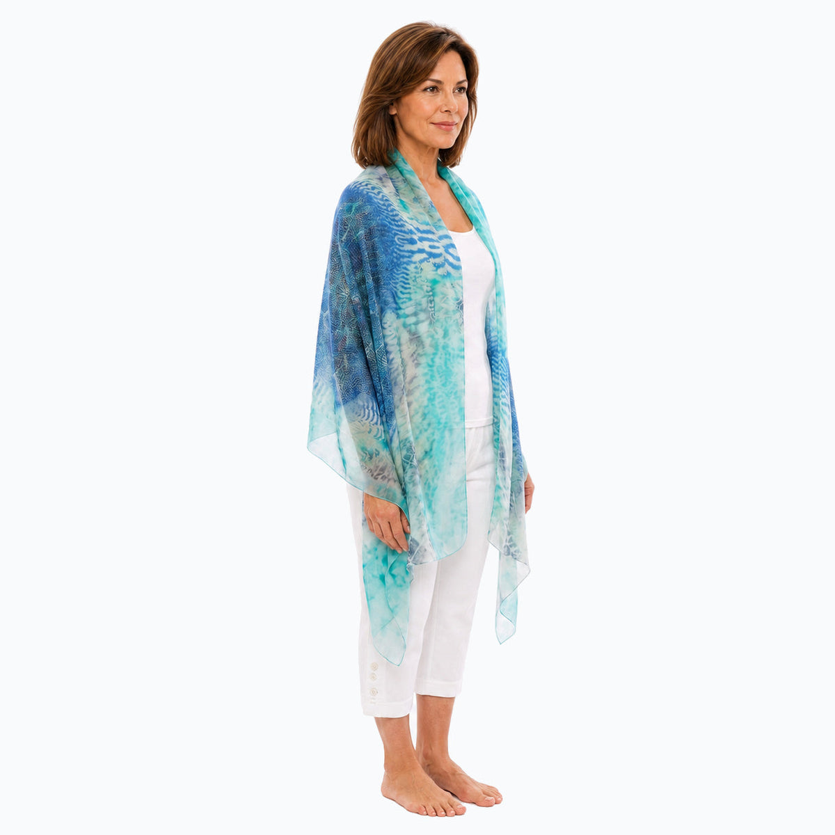 Three-quarter open-drape view of the Claire Powell Marine scarf with white capri pants and bare feet