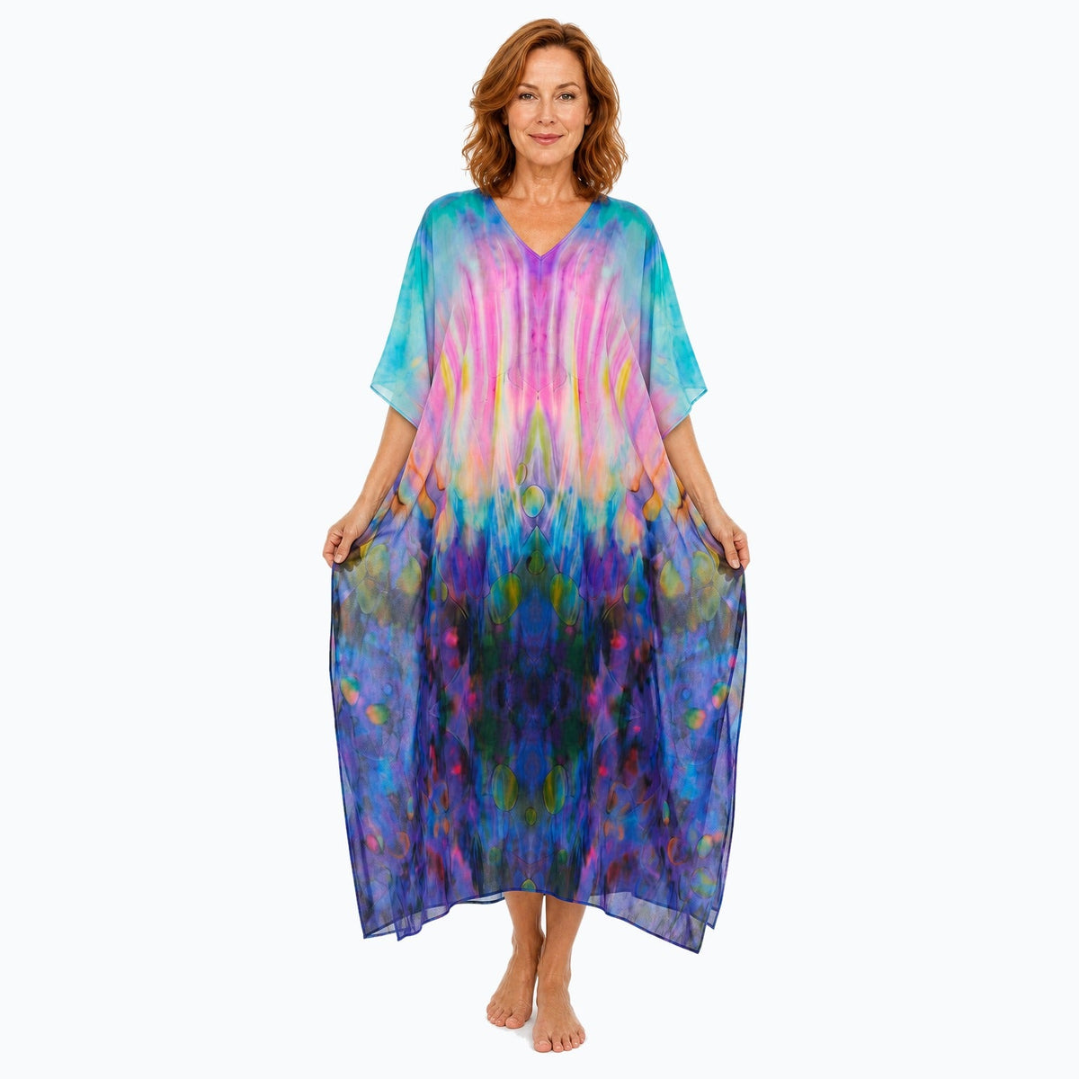 Claire Powell Opulence midi kaftan dress on a mature woman, fabric-showing pose