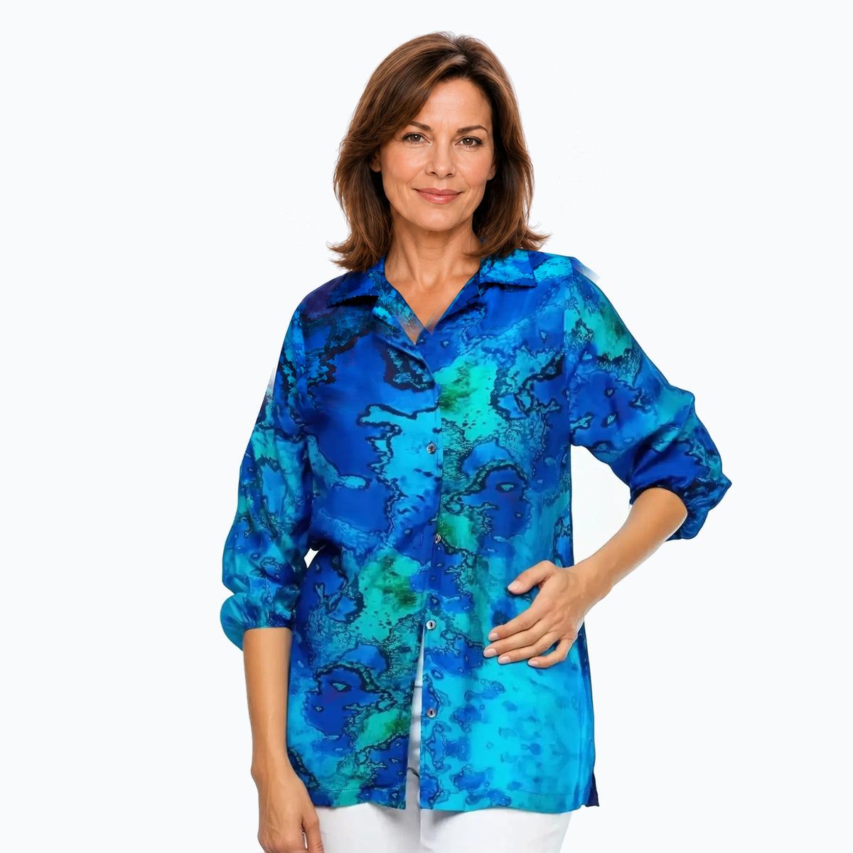 Woman wearing the Claire Powell Reef Collared Silk Shirt with naturally rolled sleeves, front untucked view