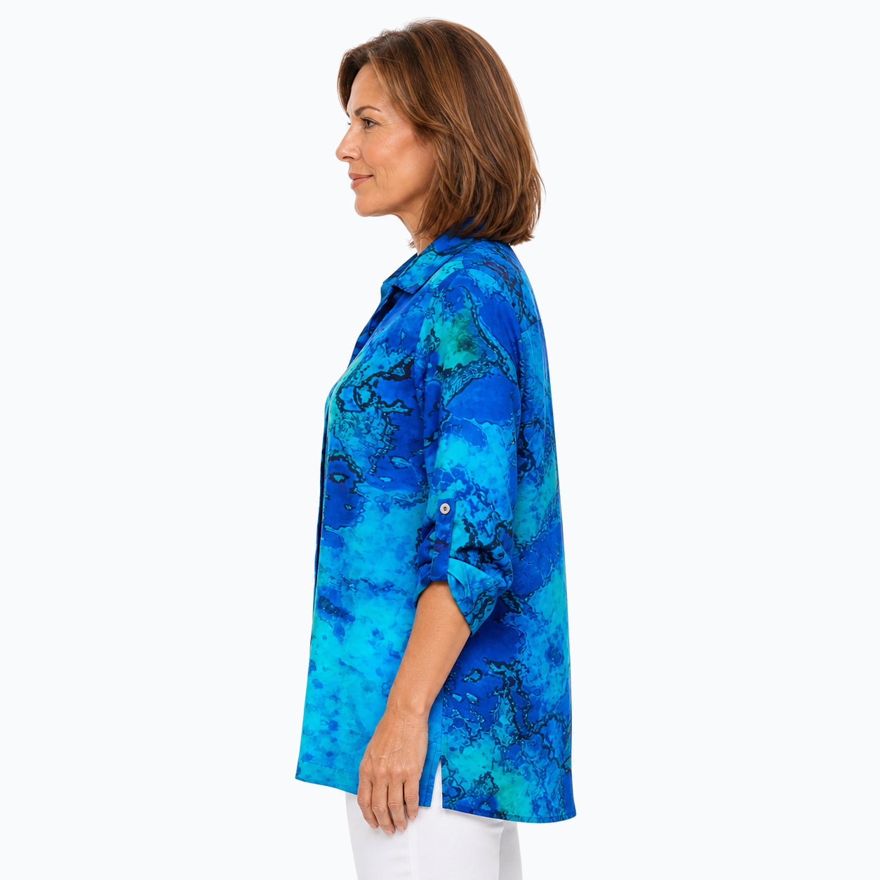 Woman wearing the Claire Powell Reef Collared Silk Shirt, side untucked view