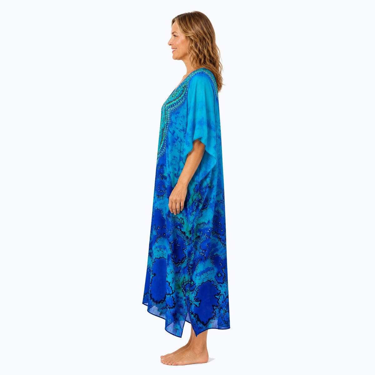 Claire Powell Reef midi kaftan dress on a mature woman, side view