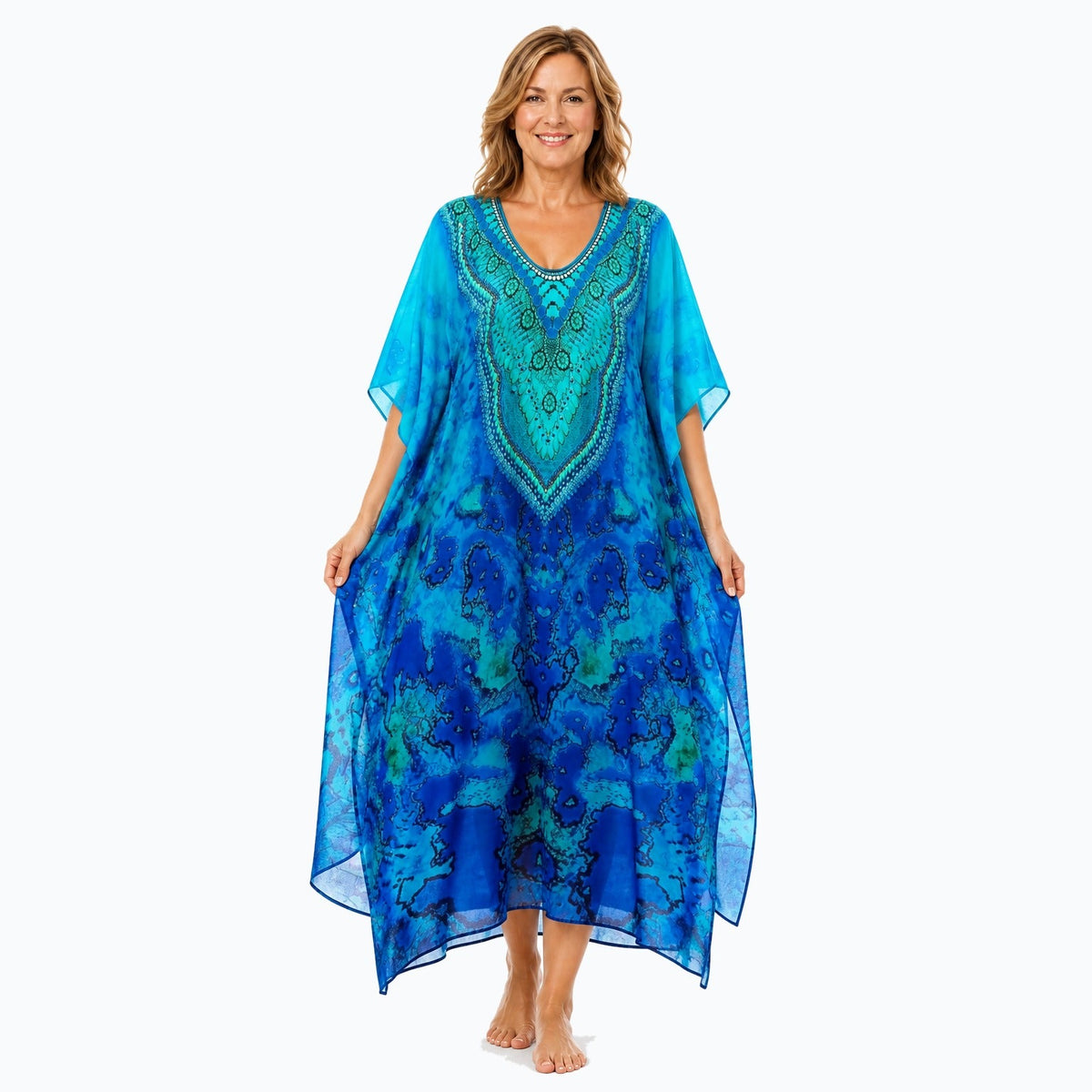 Claire Powell Reef midi kaftan dress on a mature woman, fabric-showing pose