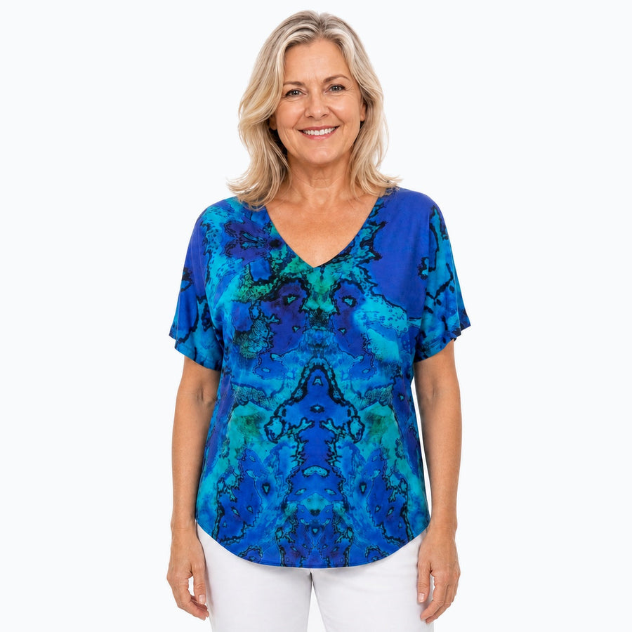 Woman wearing the Claire Powell Reef V-Neck T-Shirt, front view