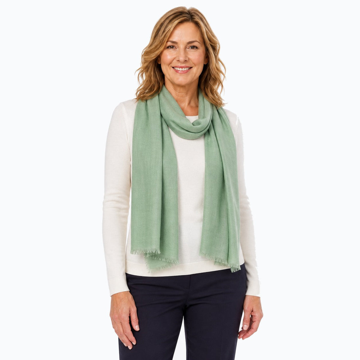 Woman wearing the Claire Powell Sage Silk Wool Scarf, three-quarter view