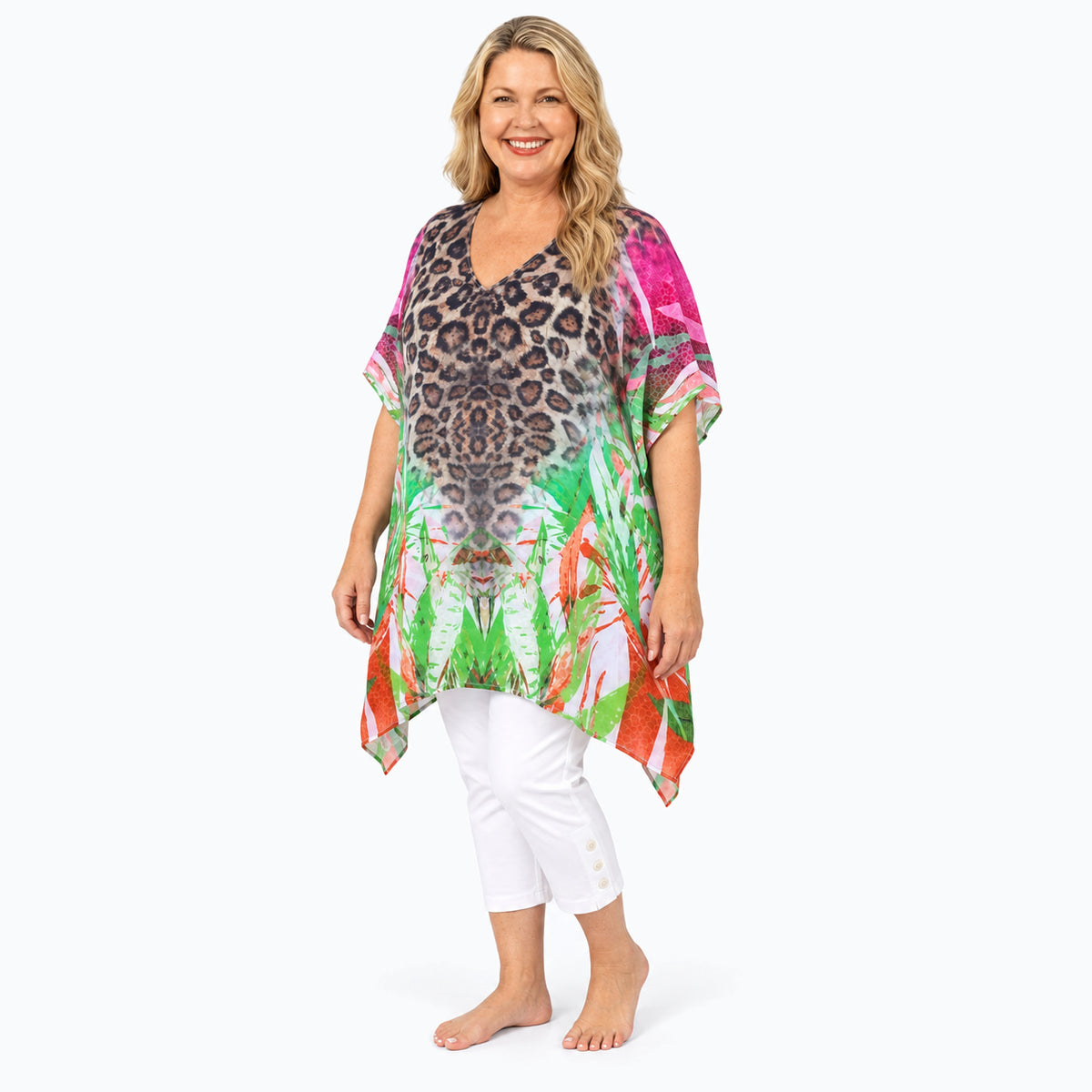 Woman wearing the Claire Powell Savannah Plus Size Kaftan Top with white capri pants and bare feet, three-quarter full-length view