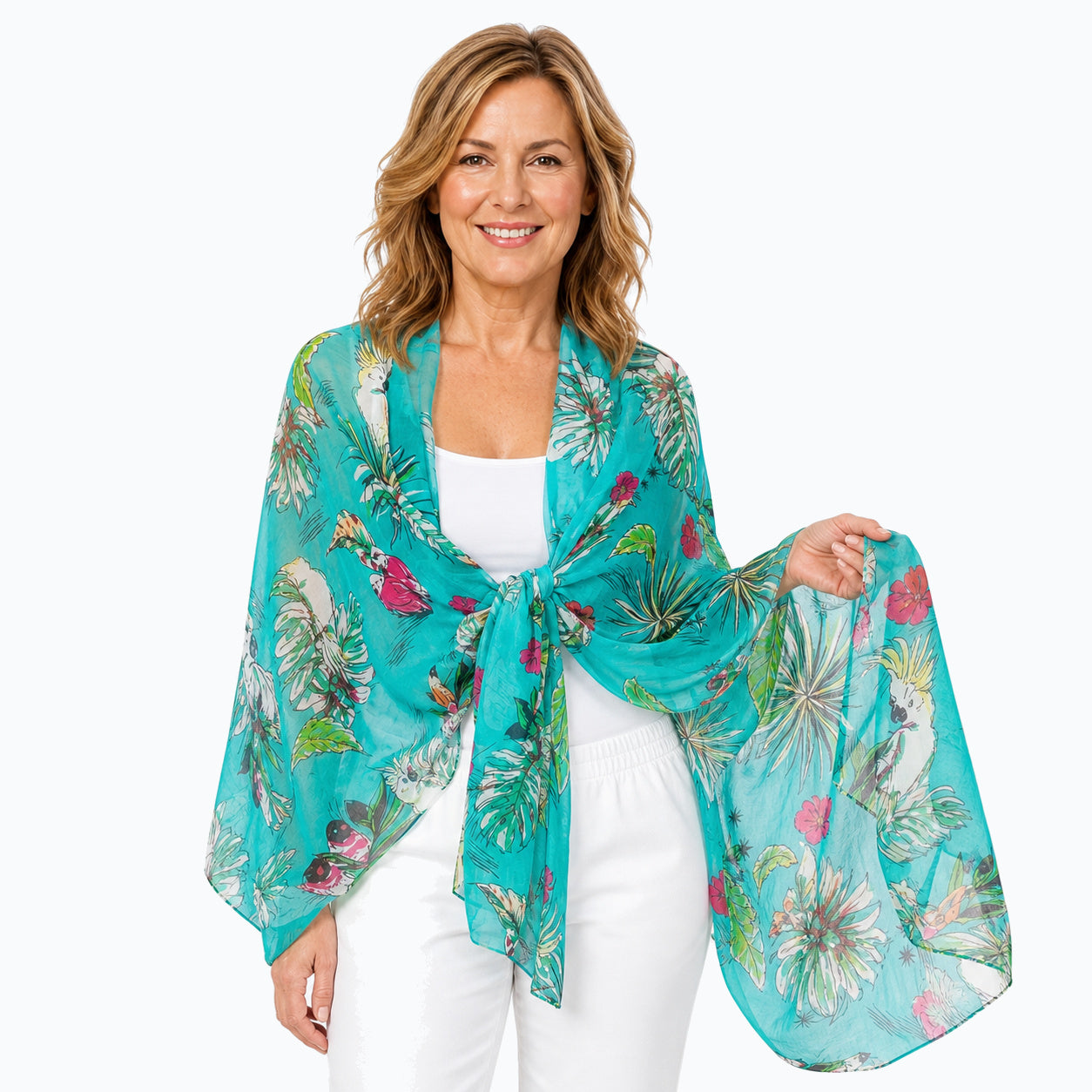 Woman wearing the Claire Powell Tweet silk scarf tied as a shawl over a white camisole and white capris, close front view