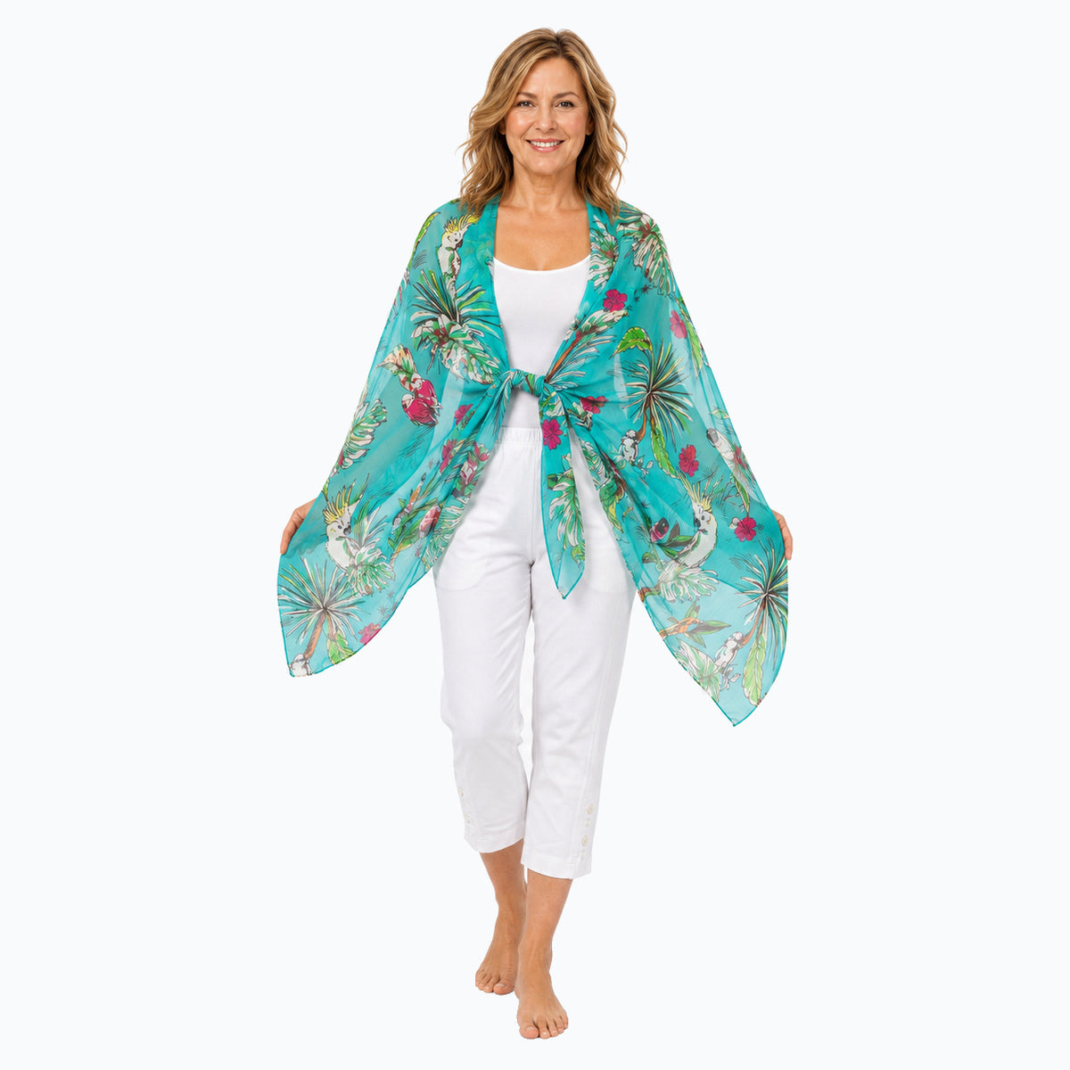 Woman wearing the Claire Powell Tweet silk scarf, tied shawl, full-body view with white capris and bare feet