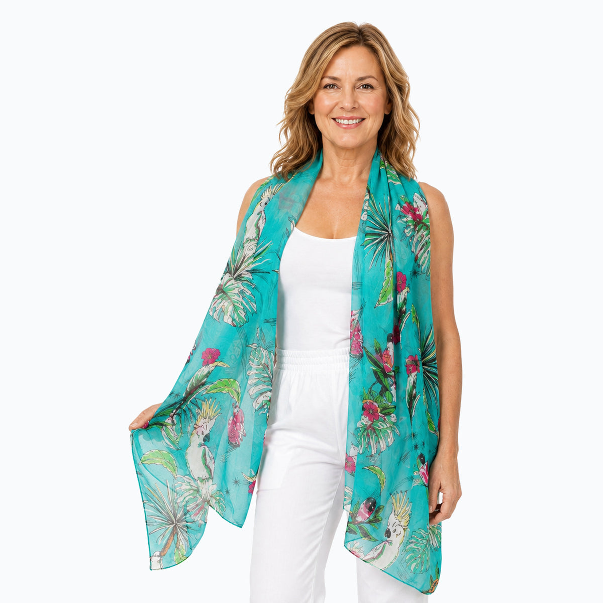 Woman wearing the Claire Powell Tweet silk scarf, draped open around the shoulders, white camisole and white capris