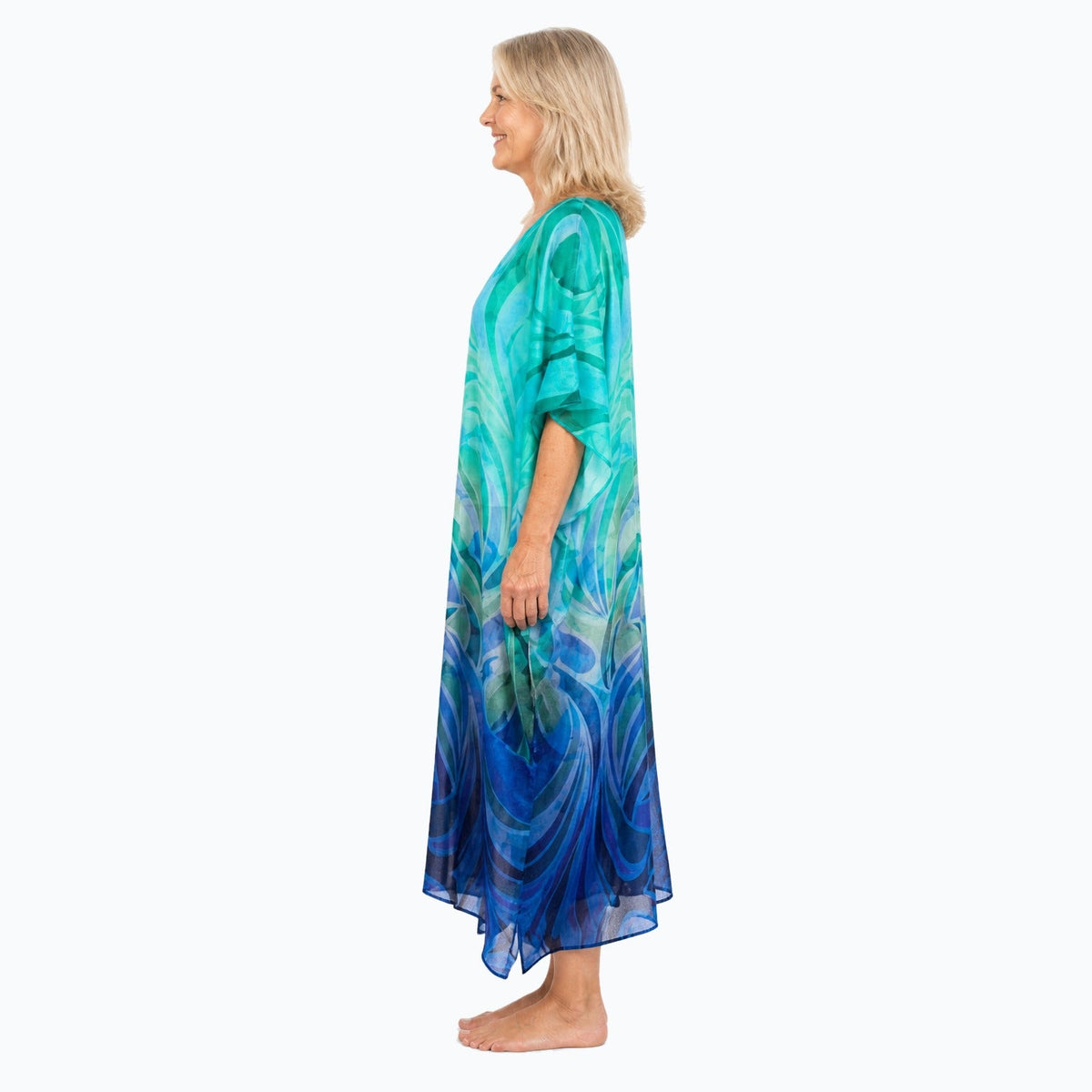 Claire Powell Waves midi kaftan dress on a mature woman, side view