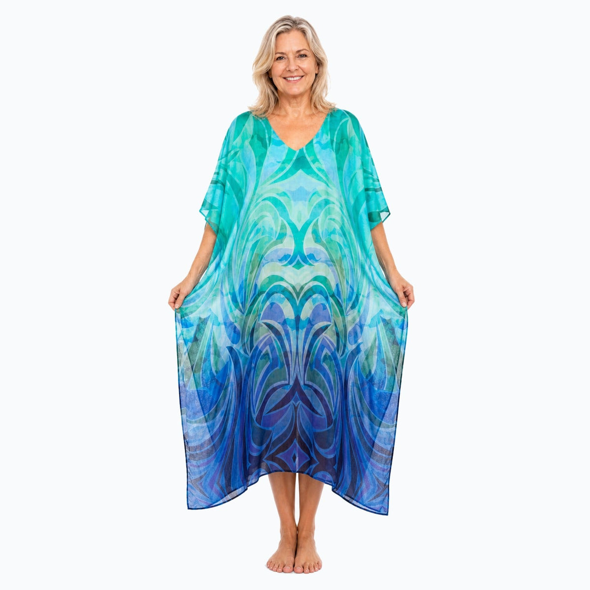 Claire Powell Waves midi kaftan dress on a mature woman, fabric-showing pose