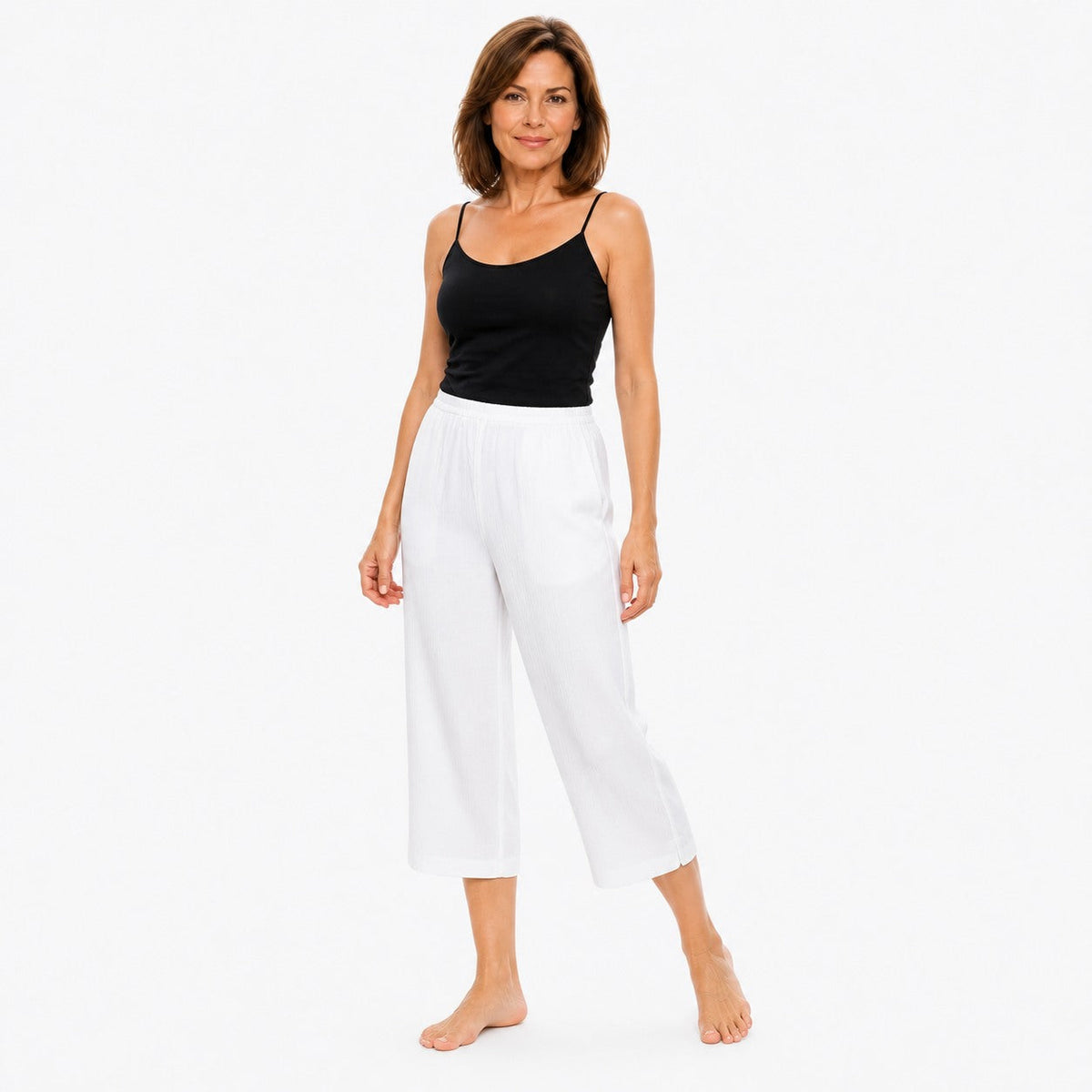 Woman wearing the Claire Powell White Viscose 7/8 Pants, three-quarter view