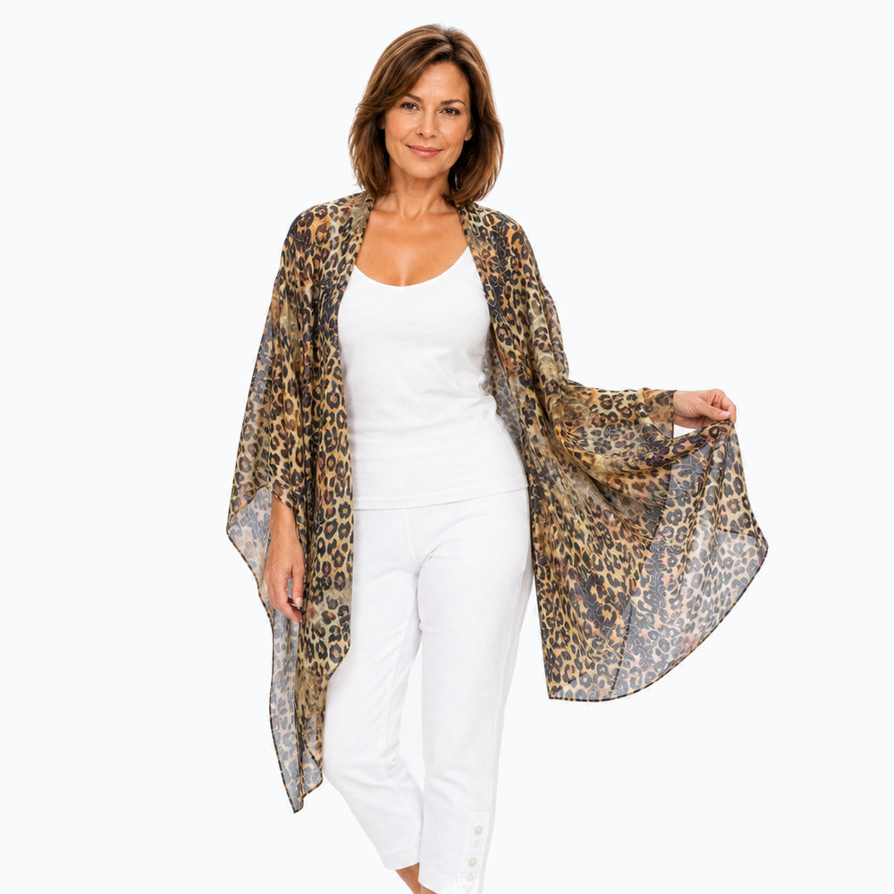 Woman wearing the Claire Powell Wilden scarf, open drape view with white camisole and white capri pants