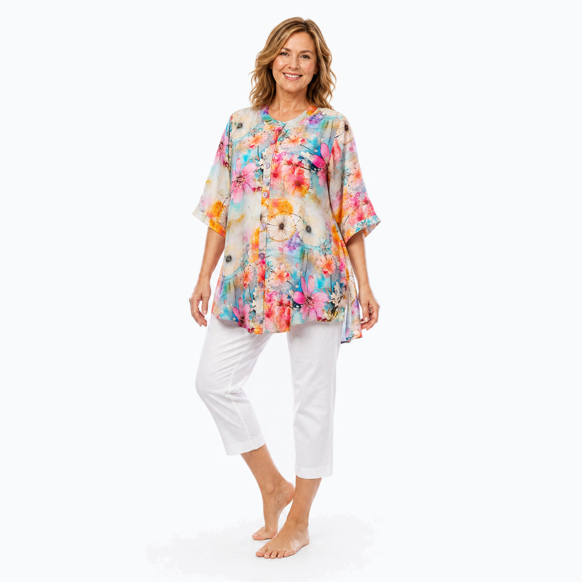 Woman wearing the Claire Powell Zen A-Line Tunic Shirt with white capri pants, full-body view