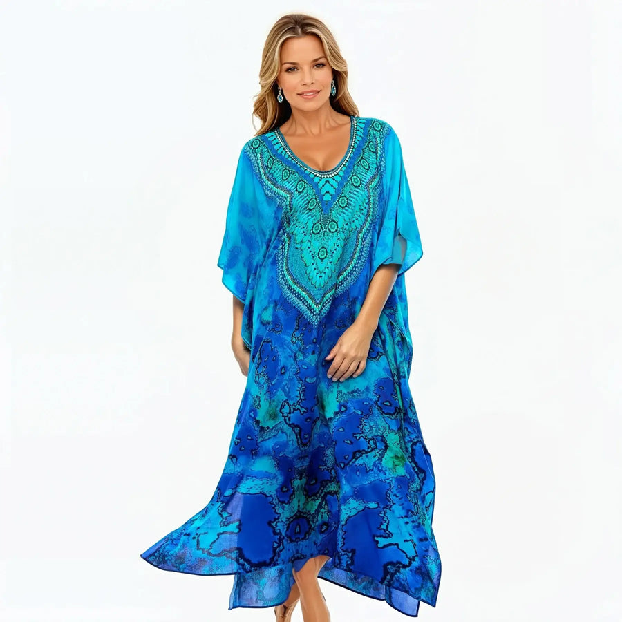 Woman wearing Claire Powell reef print blue kaftan dress, stylish and eco-friendly fashion