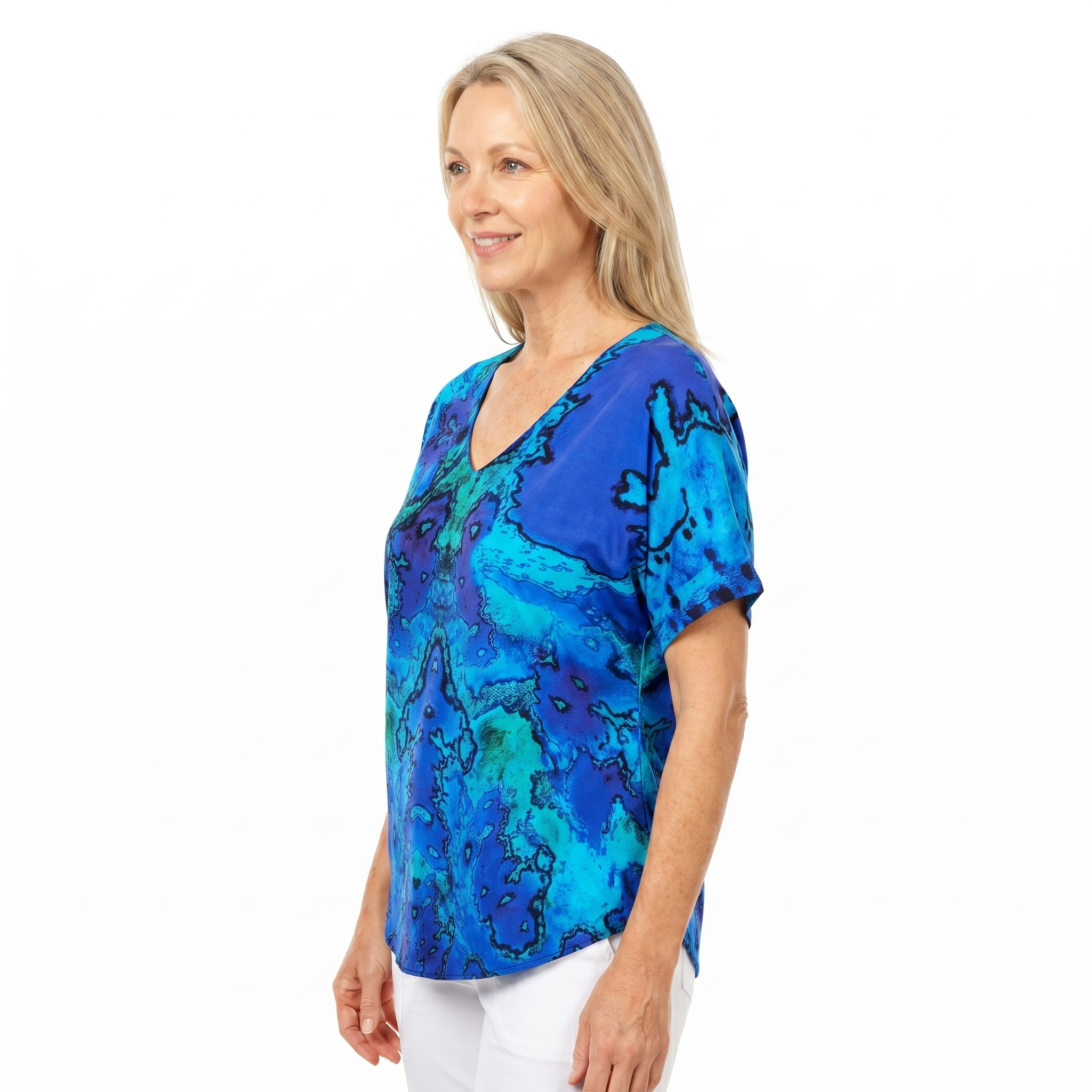 Woman wearing Claire Powell V-Neck T-Shirt in Reef print, side view, white studio background