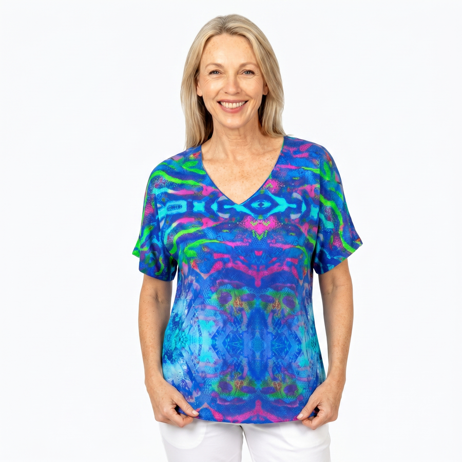 Woman wearing Claire Powell V-Neck T-Shirt in Mirage print, front view, white studio background