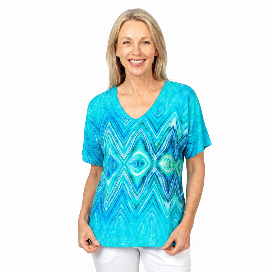 Woman wearing Claire Powell V-Neck T-Shirt in Serenity print, front view, white studio background