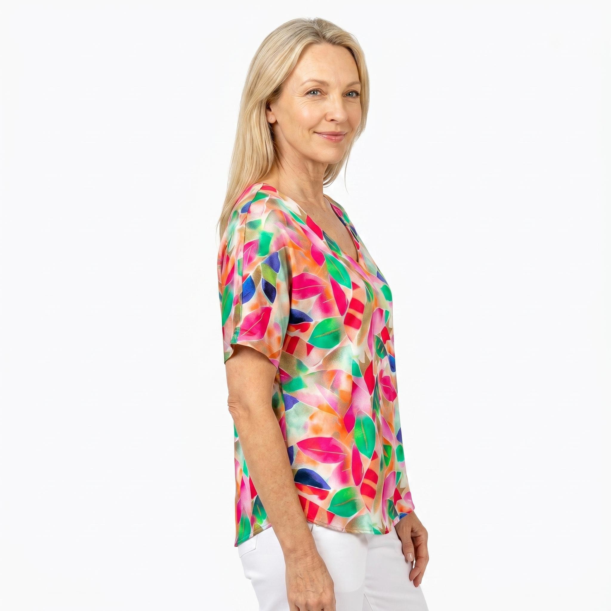 Woman wearing Claire Powell V-Neck T-Shirt in La Peach print, side view, white studio background