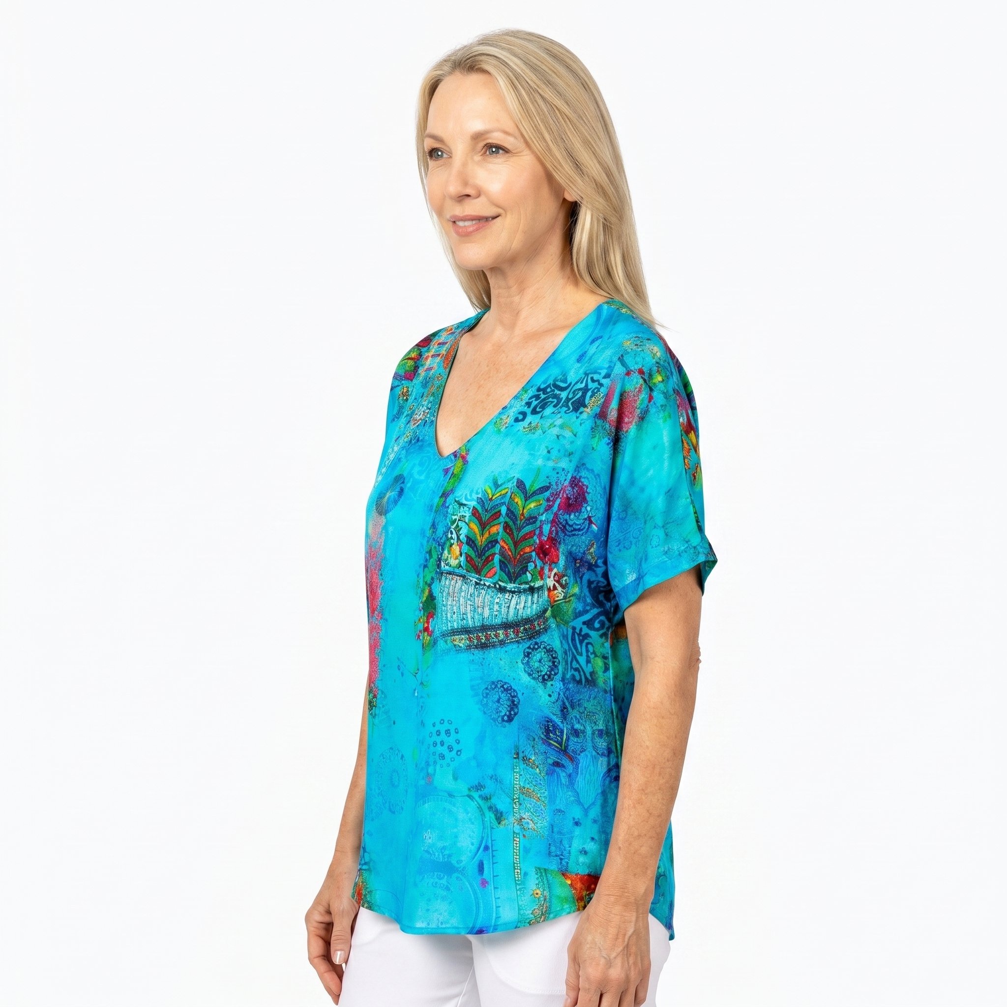 Woman wearing Claire Powell V-Neck T-Shirt in Paradise print, side view, white studio background
