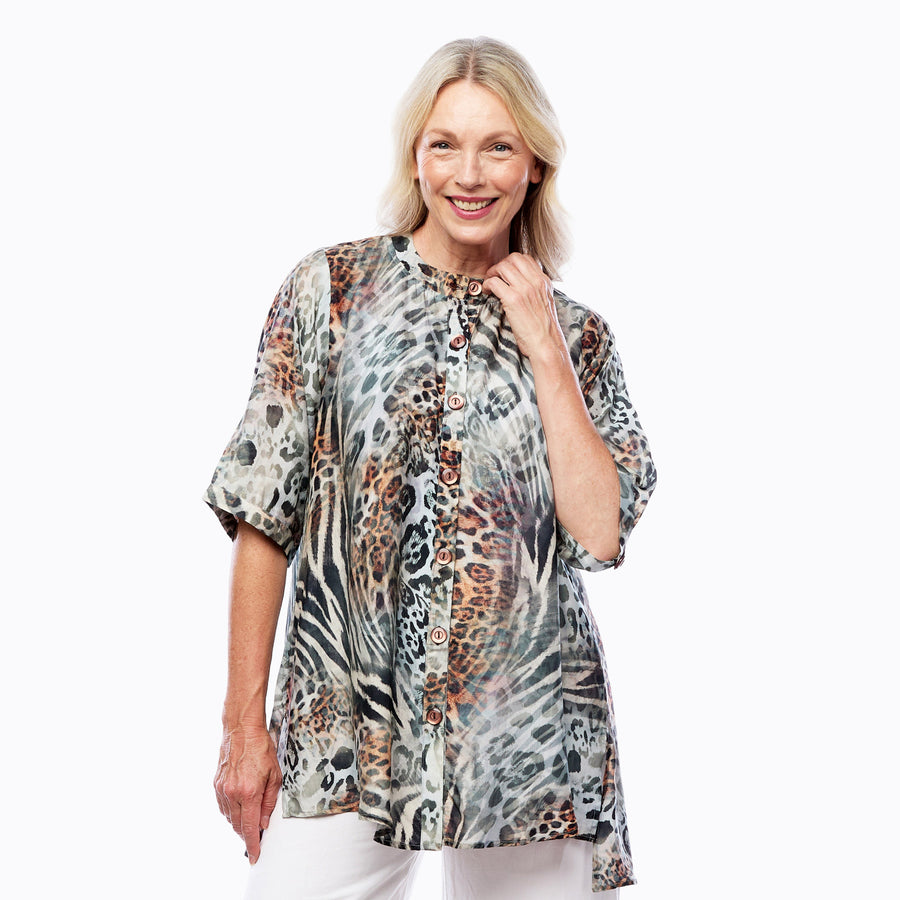 Woman wearing Claire Powell A-line Tunic Blouse in Jungle print, teal, black and brown leopard, front view