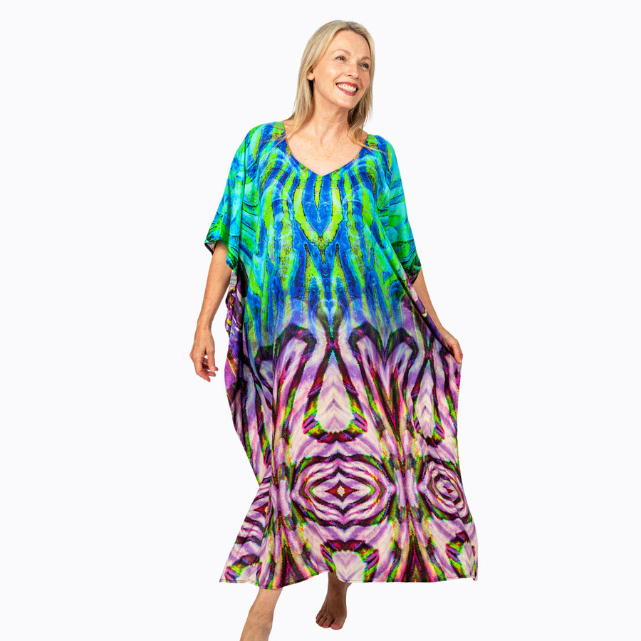 Woman wearing Claire Powell Kaftan Dress in Cascade print, cobalt and lime fading to lilac, front view, alternate pose