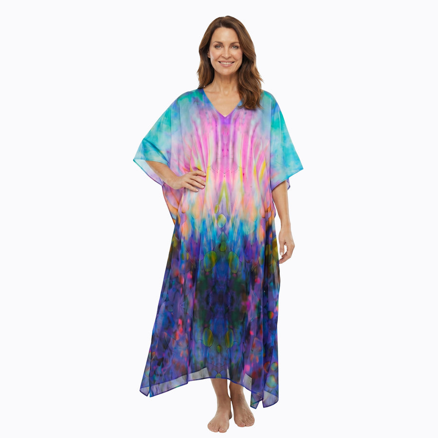 Woman wearing Claire Powell Kaftan Dress in Opulence print, blue, purple and pink, front side view