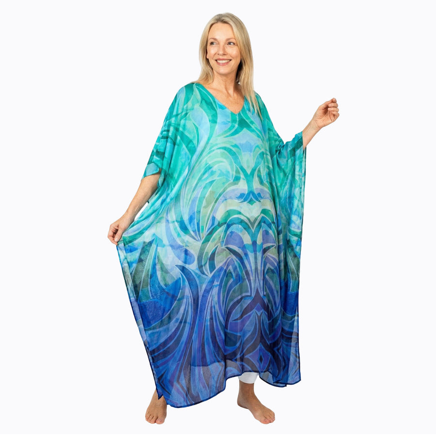 Woman wearing Claire Powell Kaftan Dress in Waves print, turquoise fading to navy, front view, alternate pose