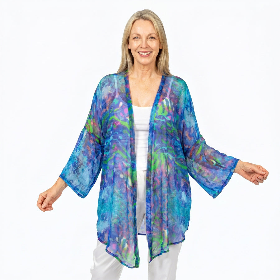 Woman wearing Claire Powell Cotton Chiffon Kimono Cover-Up in Mirage print, blue, violet and teal, front view