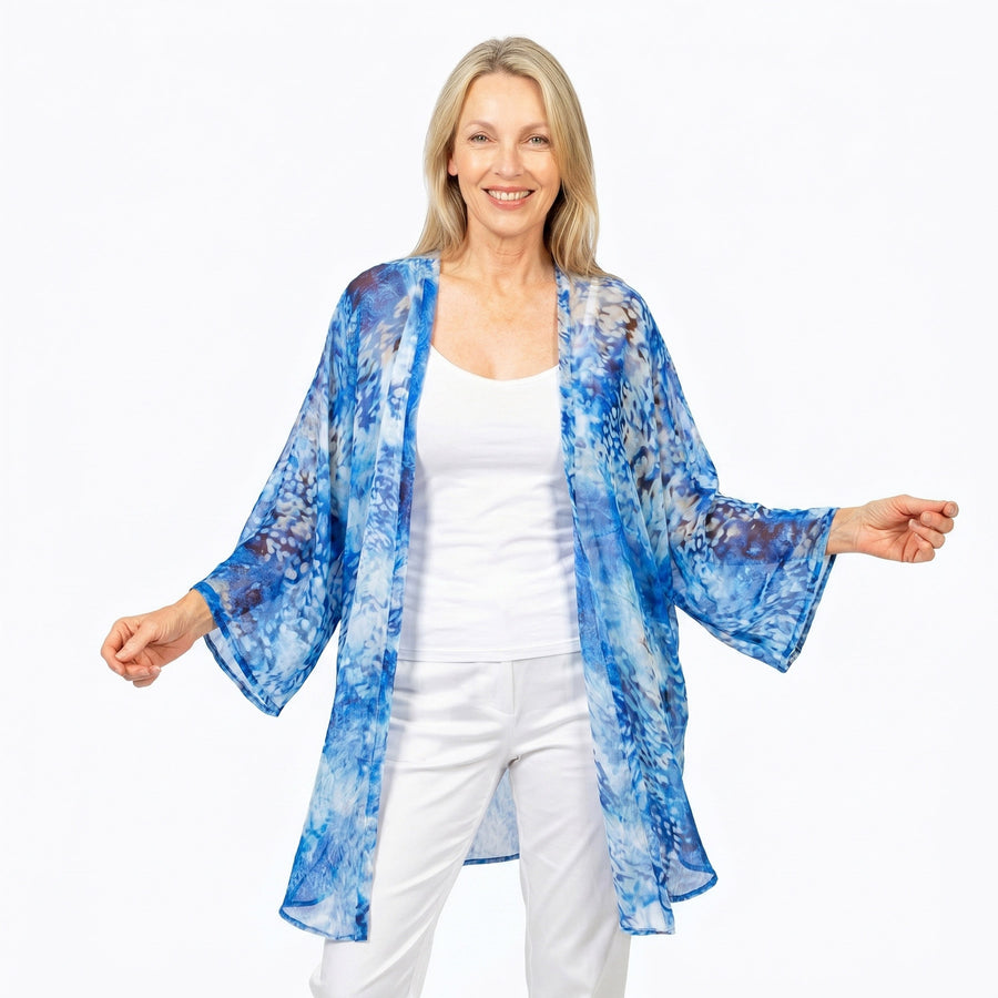 Woman wearing Claire Powell Cotton Chiffon Kimono Cover-Up in Snowcat print, grey and cream snow-leopard, front view
