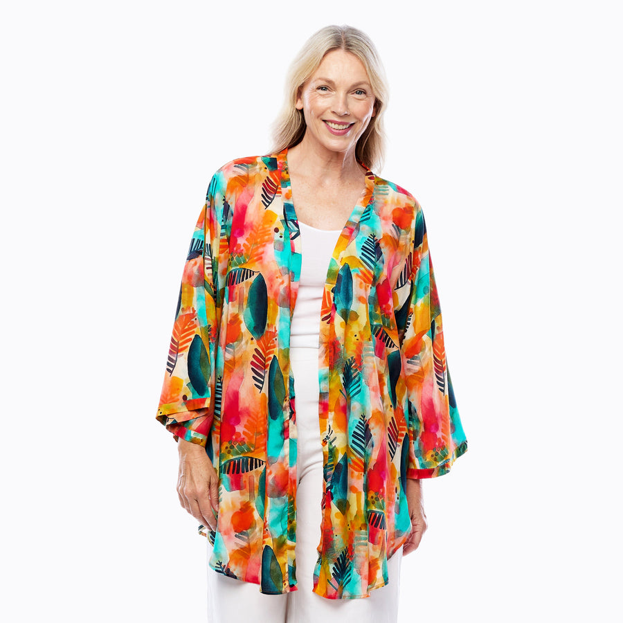 Woman wearing Claire Powell Modal Kimono Cover-Up in Tropicana print, fuchsia, orange and turquoise tropical, front view