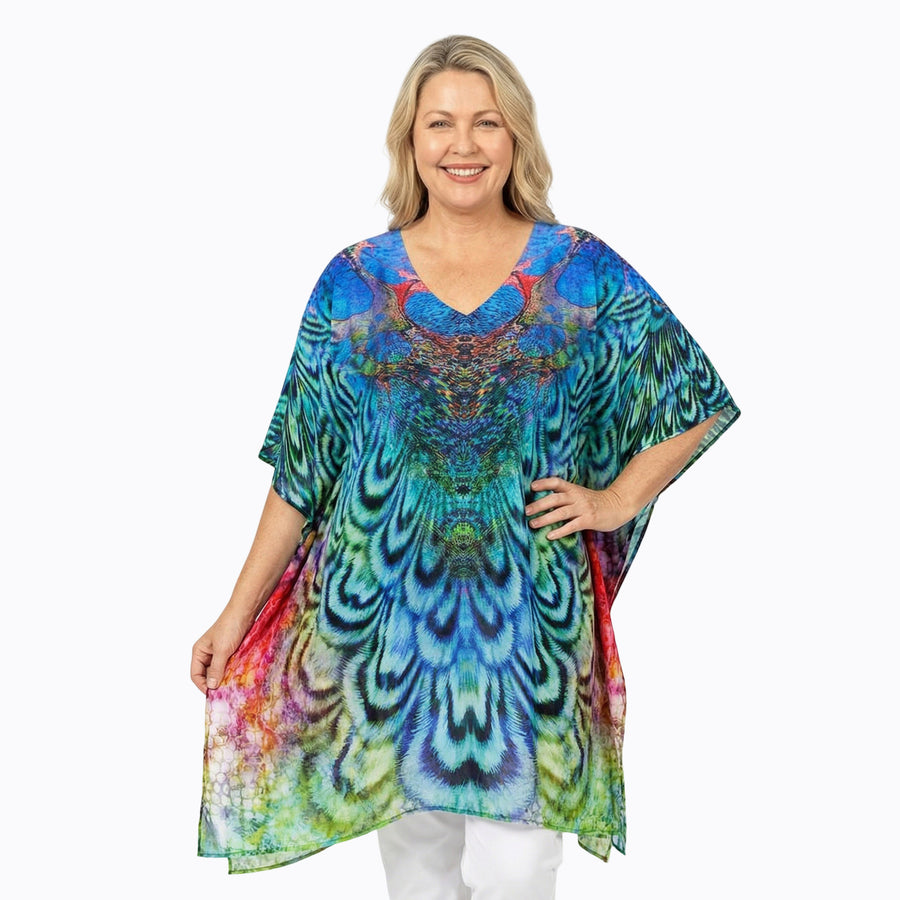 Woman wearing Claire Powell Plus Size Kaftan Top in Aves print, peacock blue and green, front view, styled fashion shot