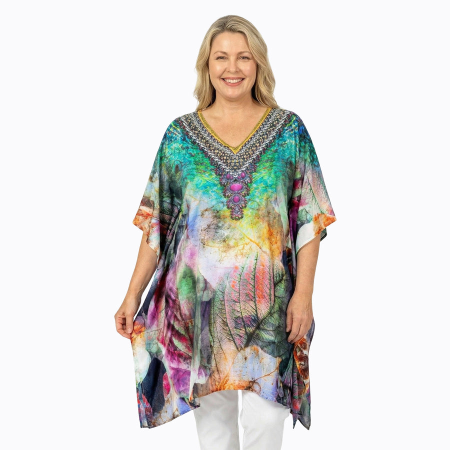 Woman wearing Claire Powell Plus Size Kaftan Top in Heaven print, colourful leaf, front view