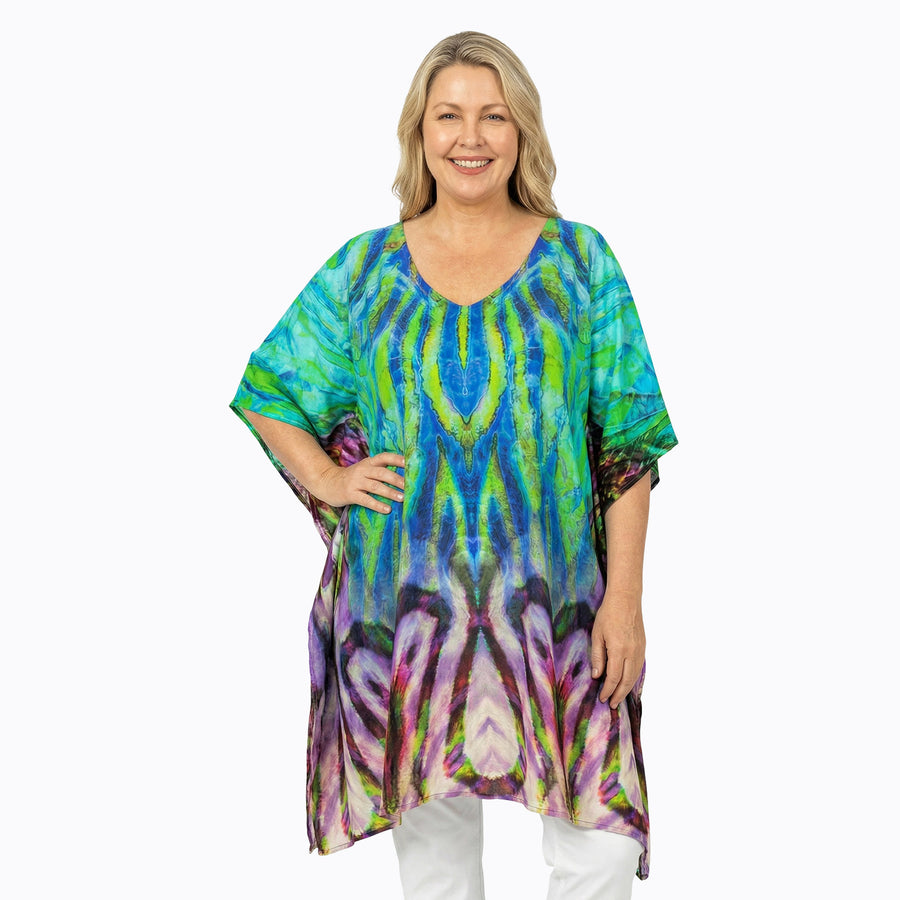 Woman wearing Claire Powell Plus Size Kaftan Top in Cascade print, cobalt and lime fading to lilac, front view, alternate pose