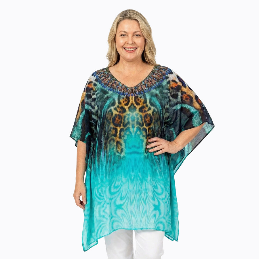 Woman wearing Claire Powell Plus Size Kaftan Top in Jungle print, teal, black and brown leopard, front view, styled fashion shot