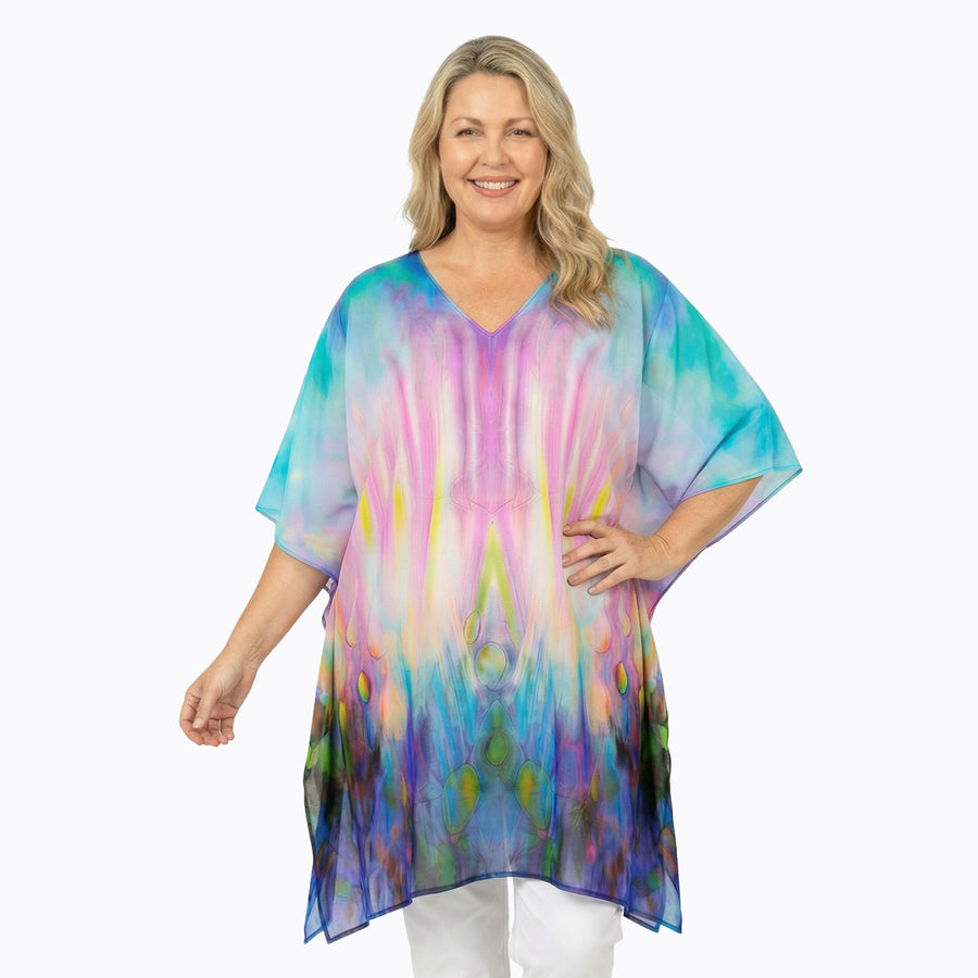 Woman wearing Claire Powell Plus Size Kaftan Top in Opulence print, blue, purple and pink, front view