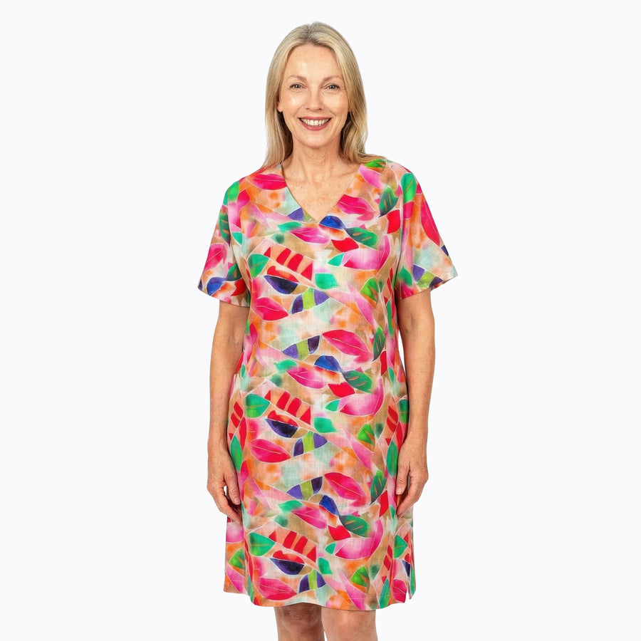 Woman wearing Claire Powell Shift Dress in La Peach print, peach, apricot and coral, front view