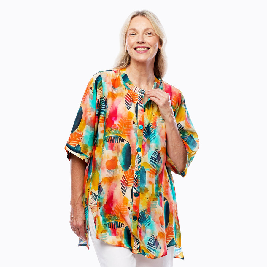 Woman wearing Claire Powell A-line Tunic Blouse in Tropicana print, fuchsia, orange and turquoise tropical, front view